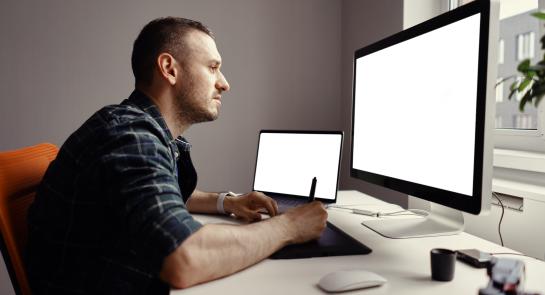 young-man-working-with-interactive-pen-display-and-2023-11-27-04-55-13-utc-scaled