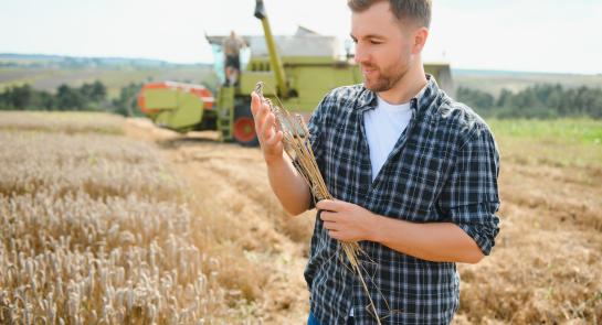 happy-farmer-proudly-standing-in-a-field-2025-03-14-15-43-25-utc