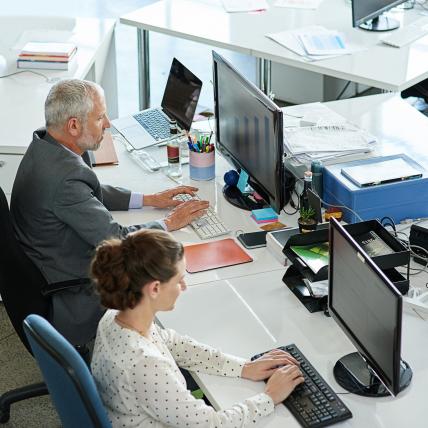 shot-of-colleagues-working-on-their-computers-whil-2023-11-27-04-51-44-utc-scaled