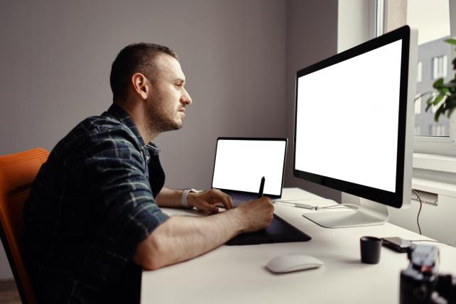 young-man-working-with-interactive-pen-display-and-2023-11-27-04-55-13-utc-scaled