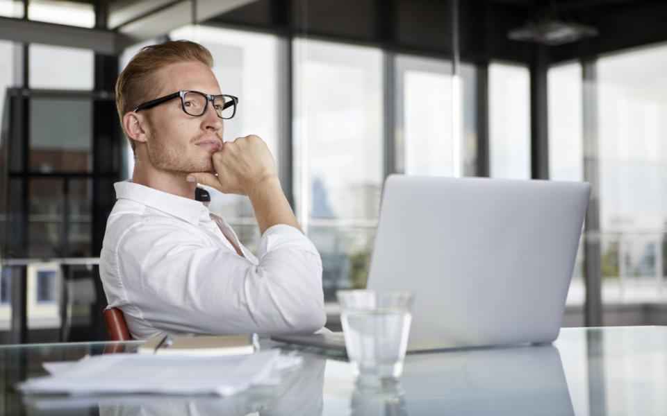 businessman-with-laptop-on-desk-in-office-thinking-2022-12-16-22-18-21-utc